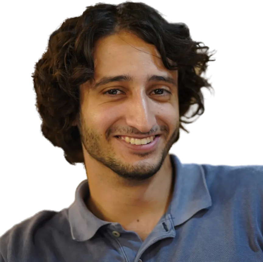 Alexandros Dellios, smiling, in a blue polo shirt
